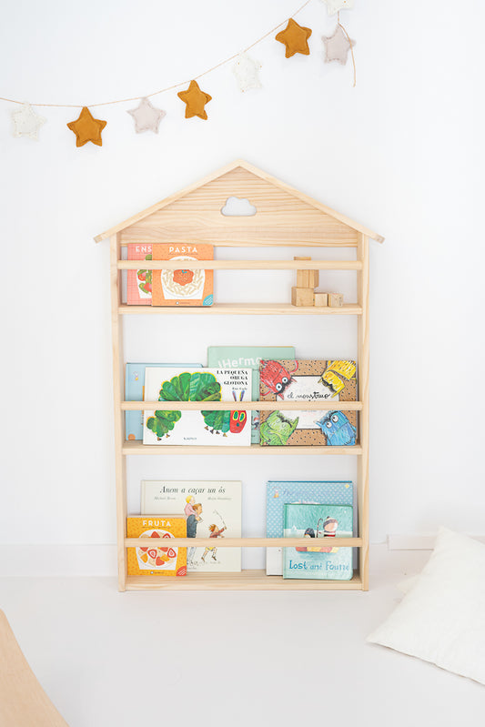 Nube children's bookcase in solid wood with Montessori design. All covers in view